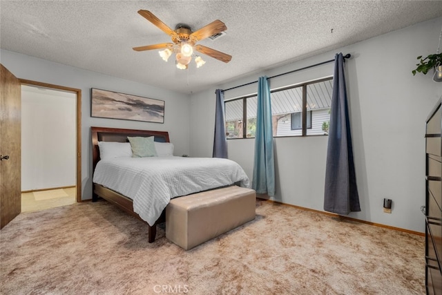 carpeted bedroom with a textured ceiling, ceiling fan, and baseboards