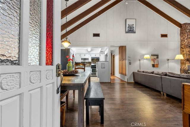 dining room featuring dark wood-style floors, beam ceiling, visible vents, and high vaulted ceiling