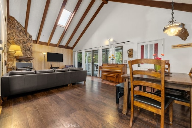 living room featuring high vaulted ceiling, a skylight, beam ceiling, and wood finished floors