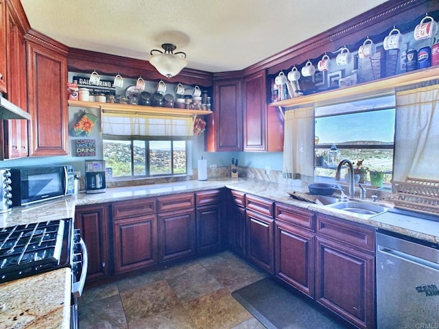 kitchen with sink, gas stove, light stone countertops, and dishwasher