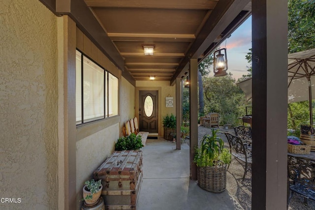 exterior entry at dusk with a patio area