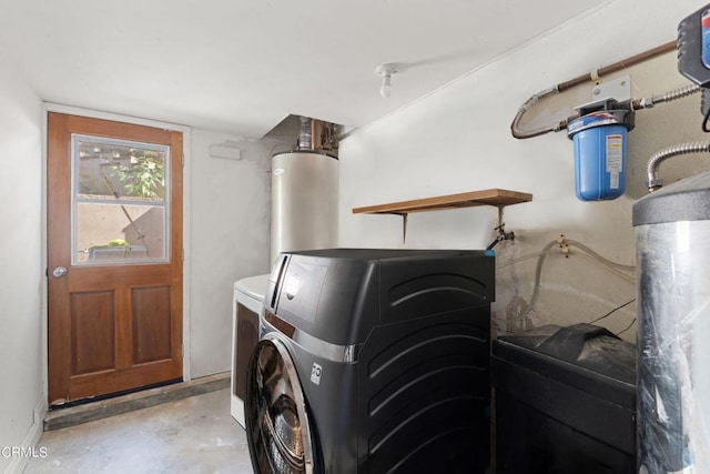 laundry area featuring water heater and washing machine and clothes dryer