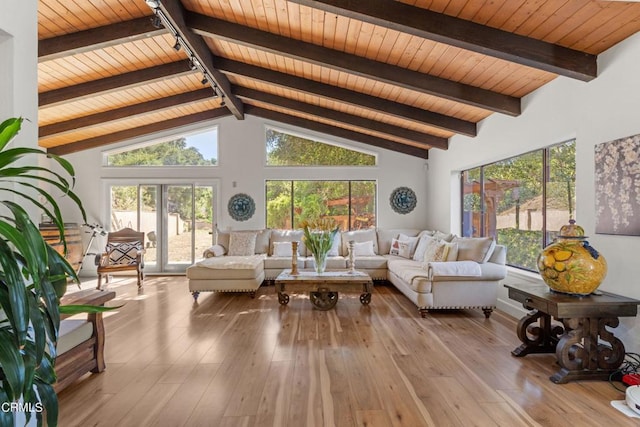 living room featuring high vaulted ceiling, light hardwood / wood-style floors, beamed ceiling, and wooden ceiling