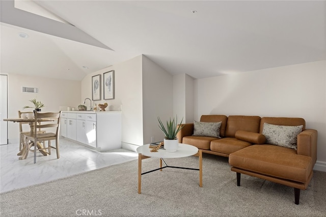 carpeted living room with lofted ceiling