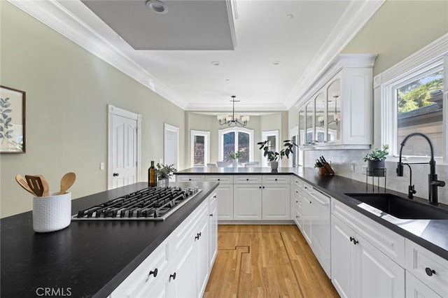 kitchen featuring white cabinetry, sink, and a wealth of natural light