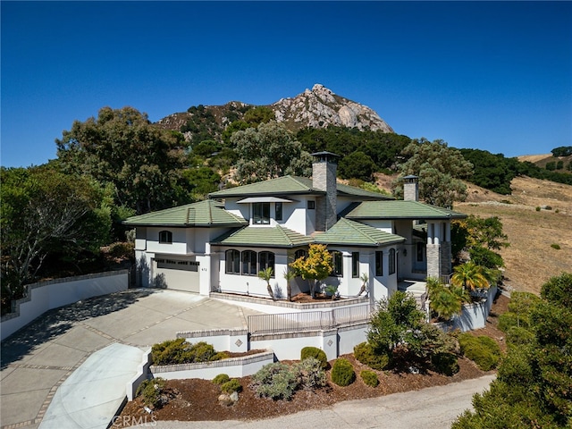 view of front facade with a mountain view and a garage