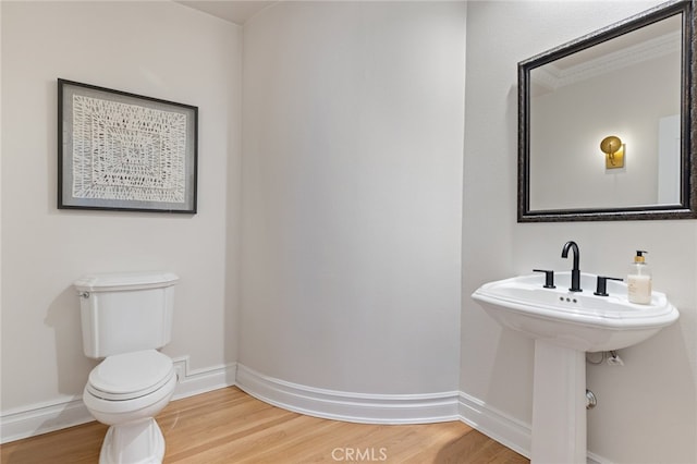 bathroom with toilet and hardwood / wood-style flooring