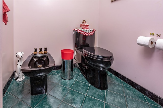 bathroom featuring tile patterned flooring and toilet