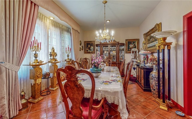 dining room with an inviting chandelier and tile patterned floors