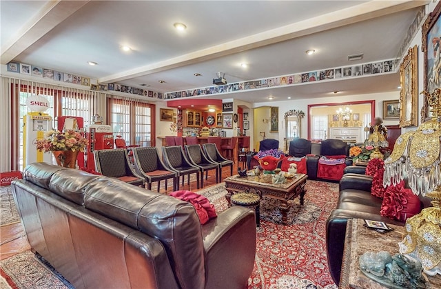 living room featuring an inviting chandelier and beam ceiling