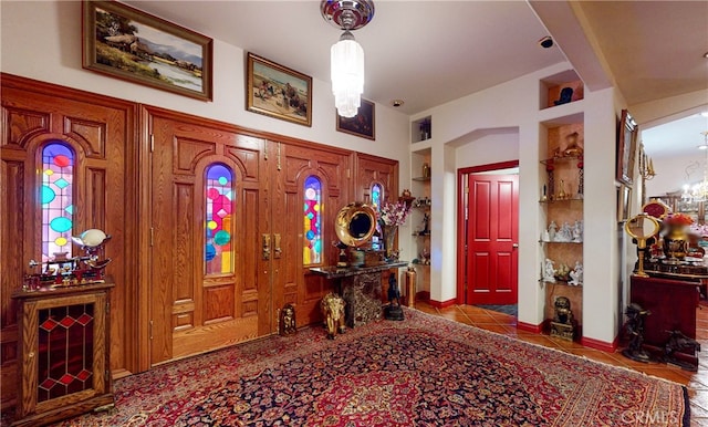 foyer entrance with a chandelier and tile patterned floors