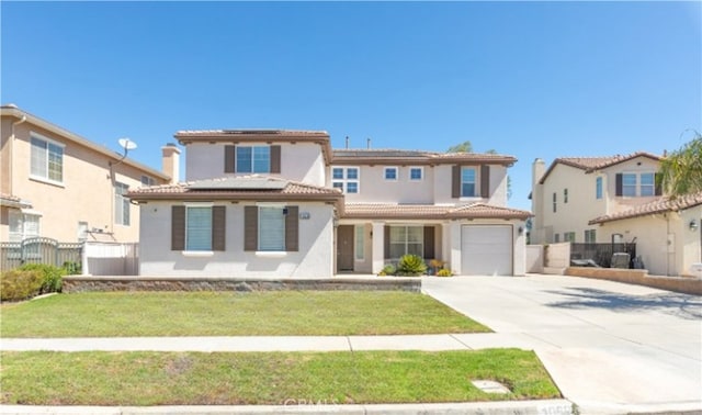 mediterranean / spanish house featuring a front lawn