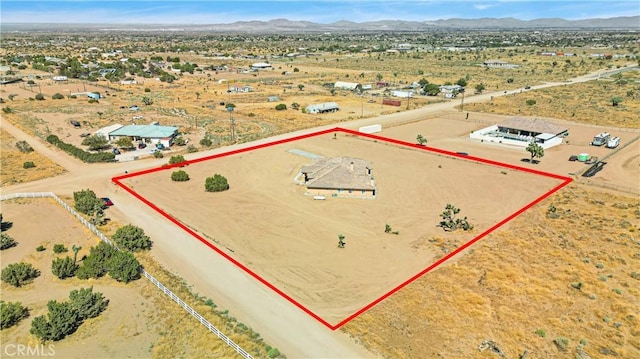 birds eye view of property with a mountain view