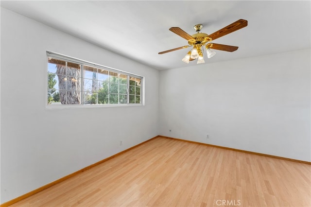 spare room featuring light wood-type flooring and ceiling fan