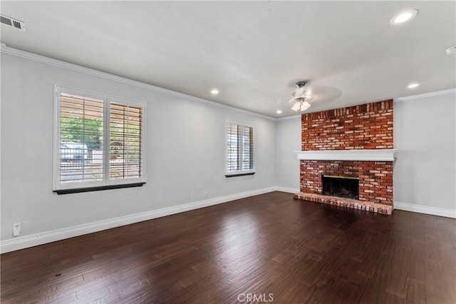 unfurnished living room with ceiling fan, a fireplace, plenty of natural light, and dark hardwood / wood-style floors