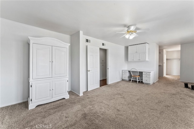 unfurnished living room featuring ceiling fan and carpet