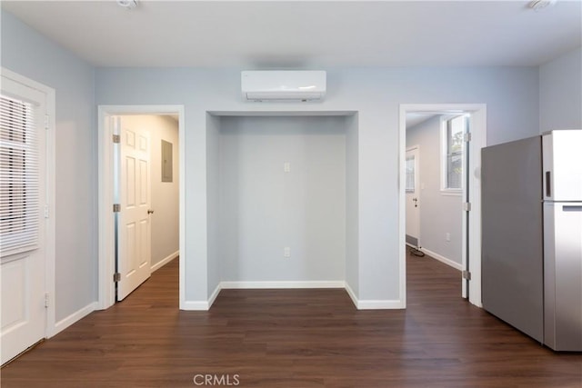 interior space with dark hardwood / wood-style flooring, fridge, a wall mounted AC, and electric panel