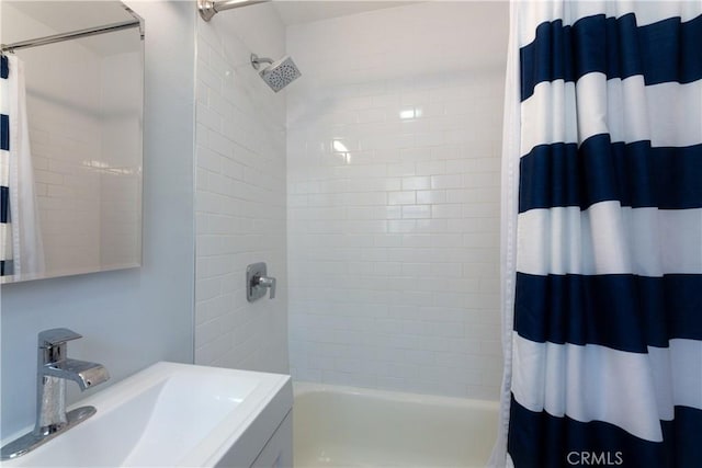 bathroom with sink and shower / bathtub combination with curtain