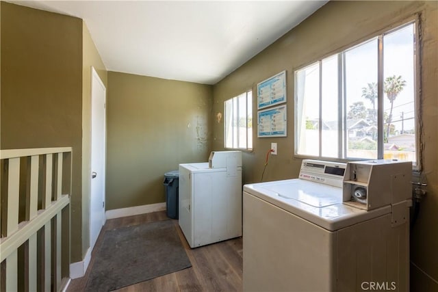 laundry area with dark hardwood / wood-style flooring and separate washer and dryer