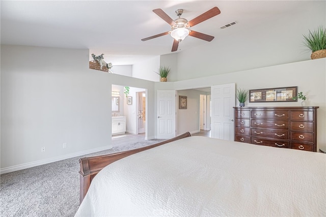 bedroom featuring high vaulted ceiling, ceiling fan, light colored carpet, and ensuite bathroom