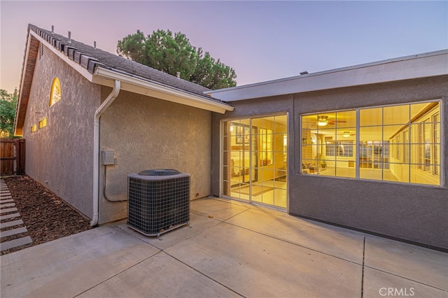 patio terrace at dusk featuring cooling unit