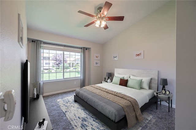 bedroom with dark carpet, vaulted ceiling, and ceiling fan