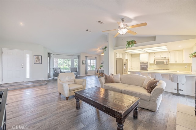 living room featuring lofted ceiling, ceiling fan, and hardwood / wood-style flooring