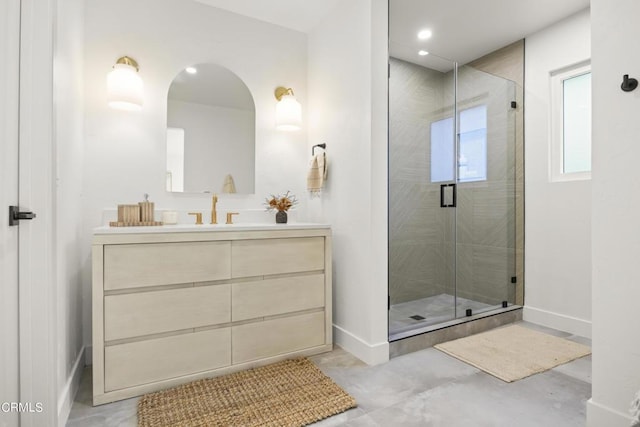 bathroom featuring vanity and an enclosed shower