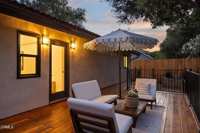 deck at dusk with outdoor lounge area