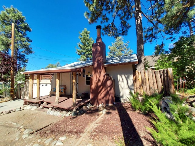 rear view of property with a wooden deck