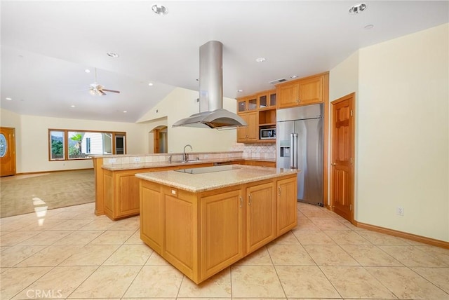 kitchen featuring island exhaust hood, appliances with stainless steel finishes, kitchen peninsula, a kitchen island, and decorative backsplash