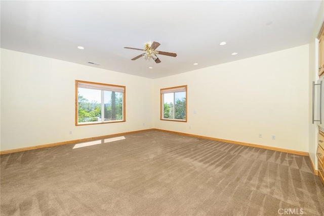 empty room with ceiling fan and carpet floors