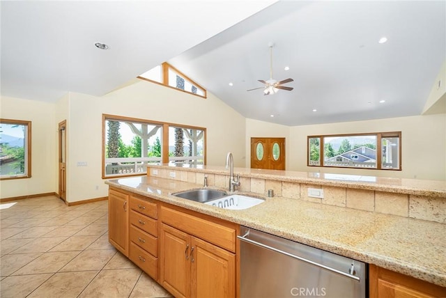 kitchen featuring dishwasher, vaulted ceiling, ceiling fan, light stone counters, and sink