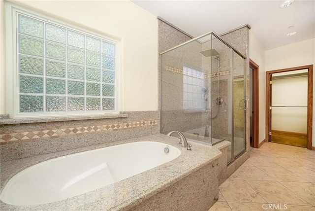 bathroom featuring shower with separate bathtub and tile patterned flooring