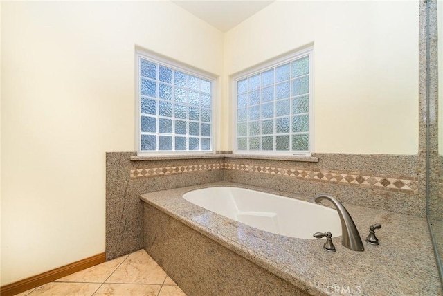 bathroom featuring tile walls, a washtub, and tile patterned floors