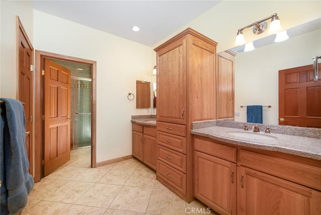 bathroom featuring an enclosed shower, vanity, and tile patterned floors