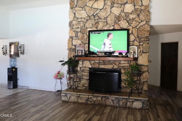 living room featuring a fireplace and dark wood-type flooring