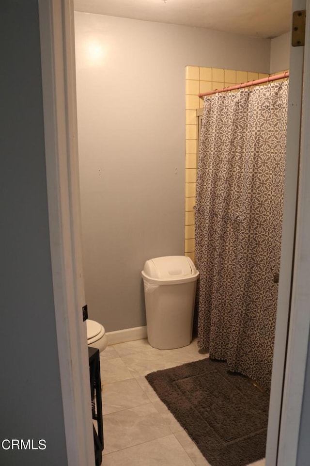 bathroom with tile patterned flooring and toilet