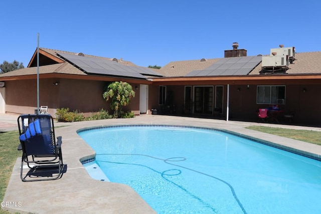 view of swimming pool with central air condition unit and a patio area