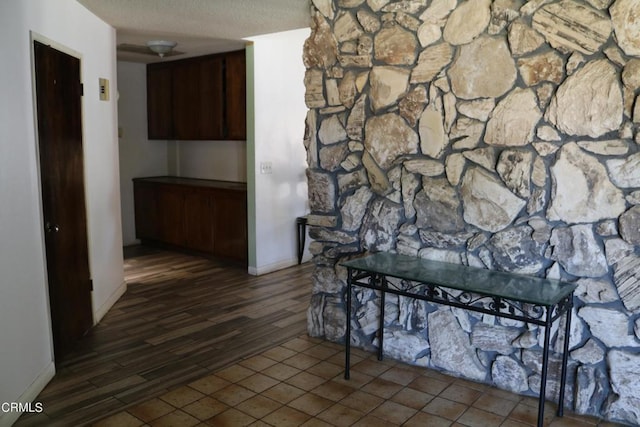 hall with a textured ceiling and hardwood / wood-style flooring