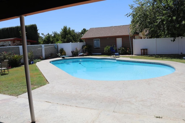 view of swimming pool with a lawn and a patio