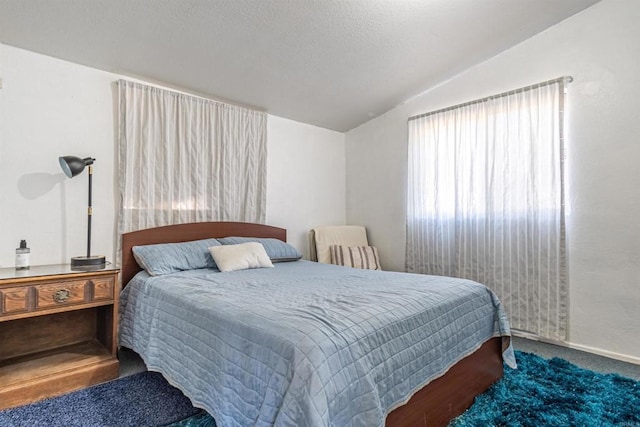 carpeted bedroom featuring lofted ceiling