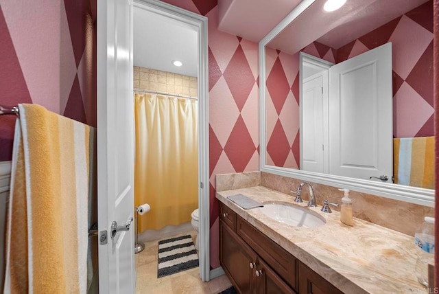 bathroom featuring a shower with shower curtain, tile patterned flooring, vanity, and toilet