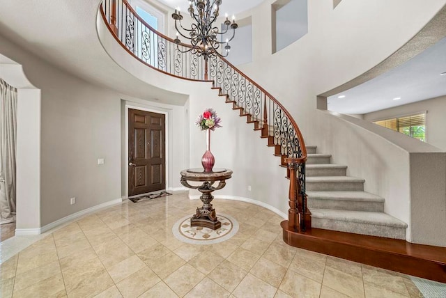 foyer with a high ceiling and an inviting chandelier