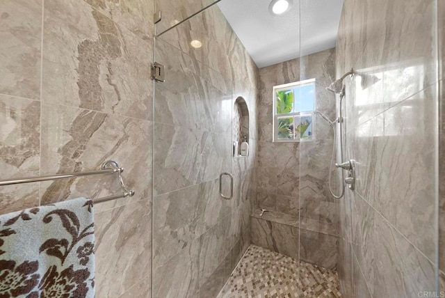 bathroom with a shower with shower door