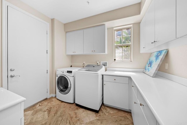 laundry room featuring cabinets and washing machine and clothes dryer