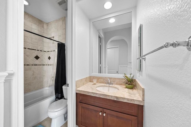 full bathroom with shower / tub combo, vanity, and toilet