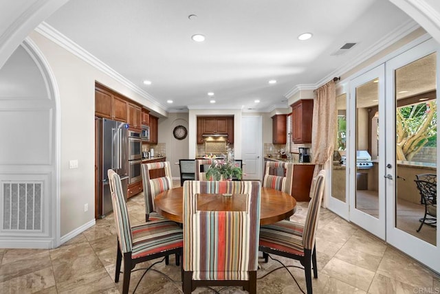 dining room with crown molding and french doors