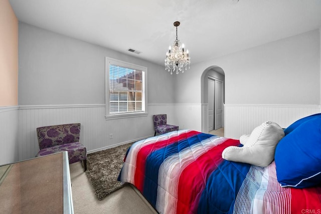 bedroom featuring carpet and an inviting chandelier