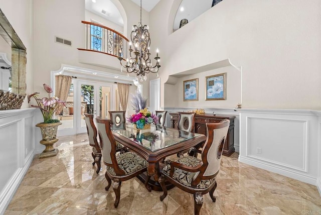 dining room with french doors, a notable chandelier, and high vaulted ceiling